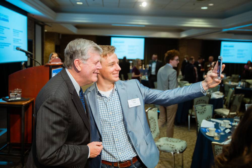 Student taking a selfie with President Haas at Scholarship Dinner 2019
